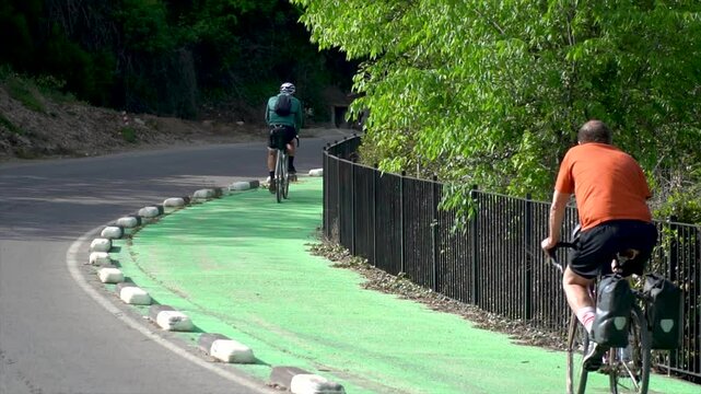 Cyclists in slow motion on the bike lane.