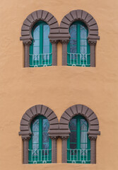 Green windows of a orange building
