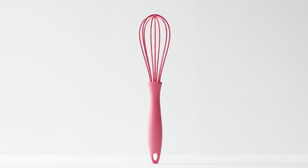 Pink silicone whisk against white background