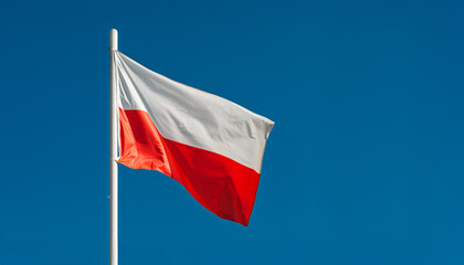 Polish National Flag Waving on Clear Blue Sky Background