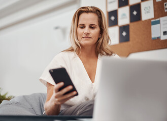 Smartphone, business woman and reading email, social media or notification on laptop in startup....