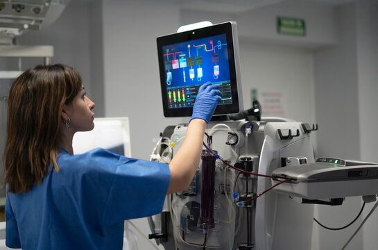Medical professional operating advanced dialysis machine