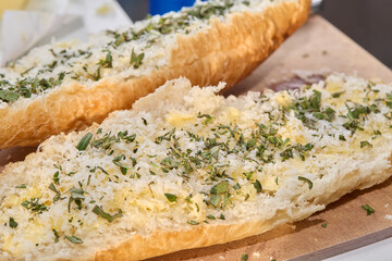 Preparing and Baking Garlic Bread with Herbs in Kitchen
