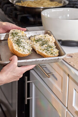 Preparing and Baking Garlic Bread with Herbs in Kitchen
