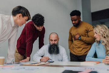 Business team analyzing financial data and discussing strategy in modern office