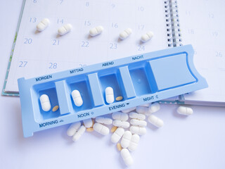 Tablets in a special pill box for each time of the day. A symbol of treatment planning and health care, especially for chronic conditions.