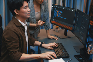 IT developers discussing with point to intelligent website development coder system running data...