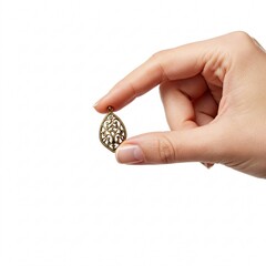 Hand holding gold pendant, isolated on white background.