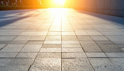 Fototapeta premium Golden light illuminates a cobblestone path, suggesting a peaceful, reflective moment during a tranquil autumn evening.