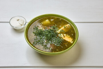 Traditional green sorrel soup with herbs and egg