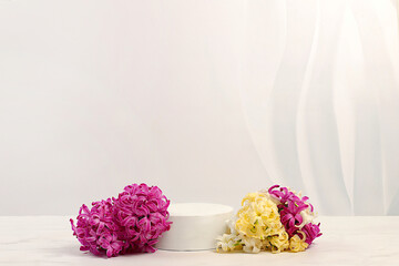 Abstract beautiful flower arrangement with hyacinths,banner.Empty product podium and fresh live spring flowers.Stage for business concept.Minimal modern aesthetics and elegant beauty concept