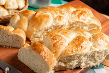 Homemade bread, a beautiful breakfast table with delicious homemade bread on a rustic wooden surface with a tablecloth, selective focus.