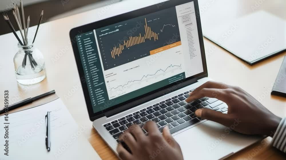 Poster typing on laptop screen, revealing financial graphs during business data analysis within modern work