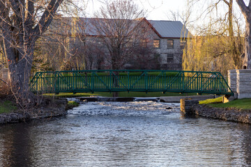 A small footbridge over a stream in spring. Stewart Park In Perth, Ontario, Canada