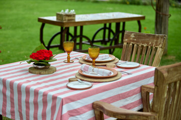 a romantic table set in a timeless hacienda, a table for two, kissed by golden light, where every detail whispers romance in the heart of the Sacred Valley 