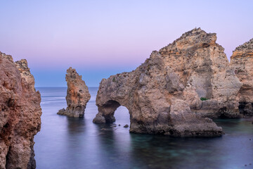 Fototapeta premium Punta da Piedade cliffs in the Algarve region of Portugal at dusk.