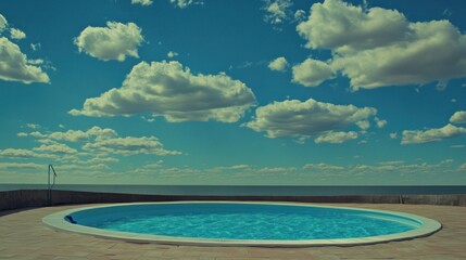 Circular pool by the sea under a cloudy sky