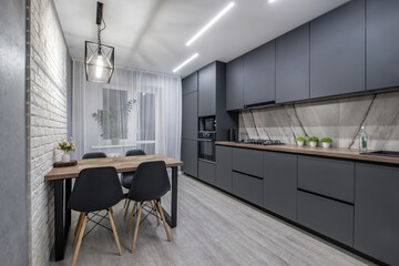 Interior of the modern luxure kitchen  in studio apartments in minimalistic style