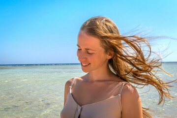 Naklejka premium Young woman person enjoy relaxing on sea, ocean beach,coast in luxury resort,smiling looking on blue clear water.Summer travel tropical recreational vacation tourism
