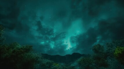 Fototapeta premium Dark green night sky with stars and silhouetted mountain ridge