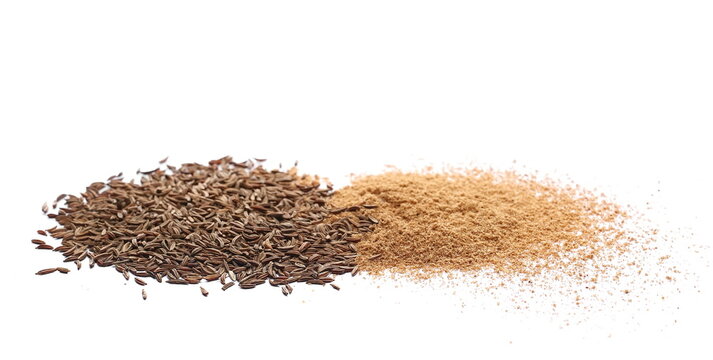 Cumin seeds and ground pile, caraway grains isolated on white background, side view