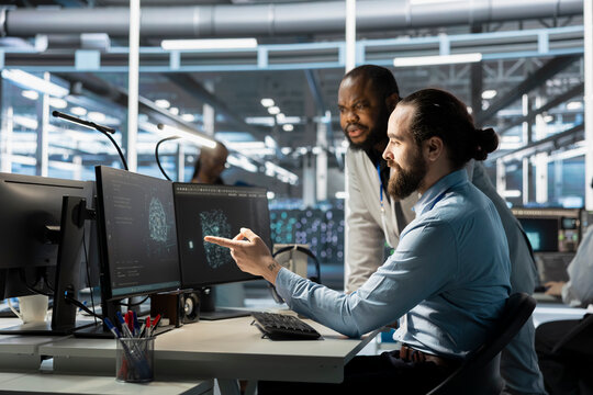 Team of programmers using computer in data center, integrating AI driven automation tools. Server farm IT experts working together, using artificial intelligence machine learning models