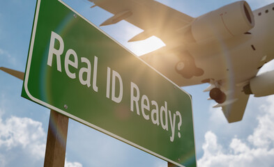 Real ID Ready? Green Road Sign with Low Flying Airplane Just Above with Landing Gear Down.