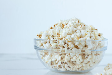 Popcorn in bowl with white background. Close-up. Copy space.