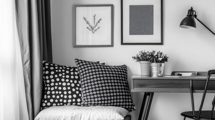 Monochrome bedroom scene with patterned pillows, clean desk, and layered textures
