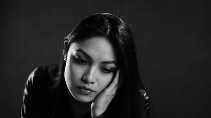 Pensive woman contemplating in monochrome portrait