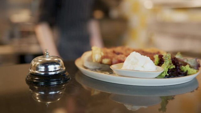 Waiter ringing service bell for ready meal