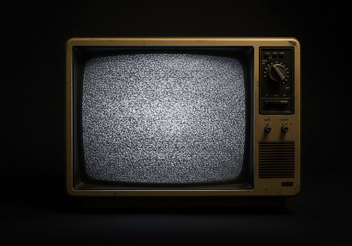 A close-up shot of an old television displaying static on a dark background.