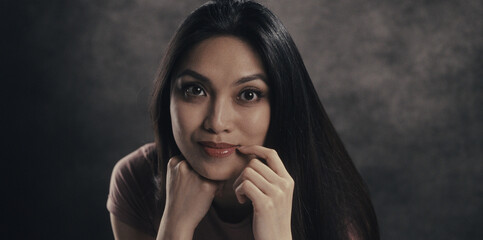 Woman resting her chin on hands, deep in thought
