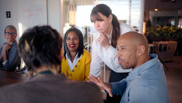 Professional businesswoman leading collaborative team meeting, diverse colleagues engaging in strategic brainstorming and sharing innovative ideas within modern office environment