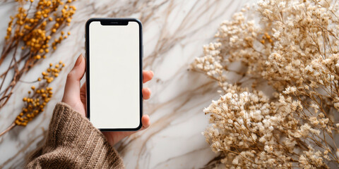 Woman Holding Smartphone with Blank Screen, Dried Flowers, Marble Background