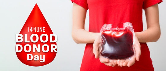 Woman with blood pack on grey background, closeup. World Blood Donor Day