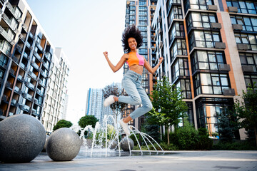Full length photo of attractive young cheerful lady jumping winner wear colorful garment spend time...