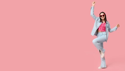 Young happy woman in stylish jeans clothes on pink background with space for text