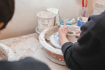person making a ceramics in an art class hands making pottery 
