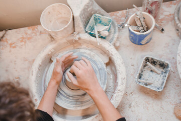 person making pottery in and wheel 