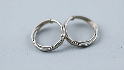 pair of silver rings sitting on top of a table