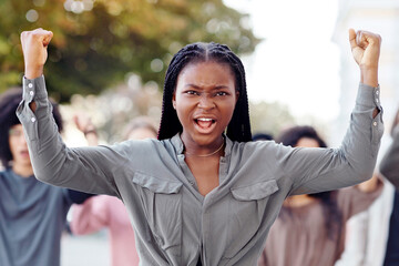 Black lady guiding multiracial group of activists, rasising fists up, showing unity and strength,...