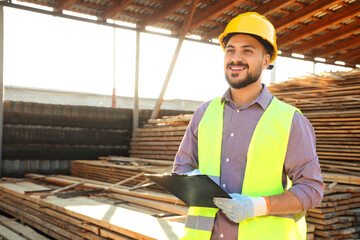 Male carpenter with clipboard at sawmill