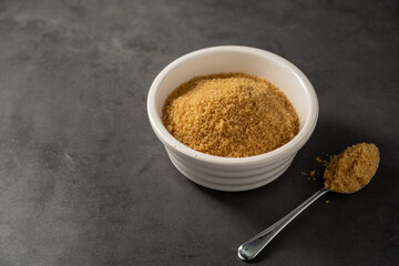 Light brown granulated sugar in a bowl. Copy space