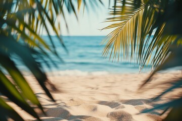 Fototapeta premium Tropical beach background with palm leaves and sand, blurred sea view. Summer vacation concept banner.