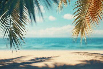 Obraz premium Tropical beach background with palm leaves and sand, blurred sea view. Summer vacation concept banner.