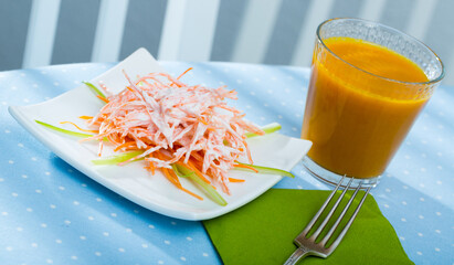 Healthy fitness breakfast with fresh carrot and celery salad and carrot juice