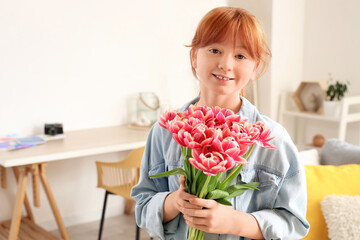 Cute redhead girl with fresh tulips at home
