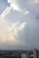 large cloud is in the sky over a city