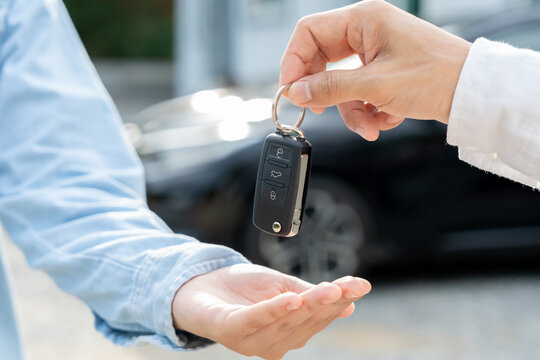 lease, rental car, sell, buy. Dealership manager send car keys to the new owner.  Sales, loan credit financial, rent vehicle, insurance,  renting, Seller, dealer, installment, car care business